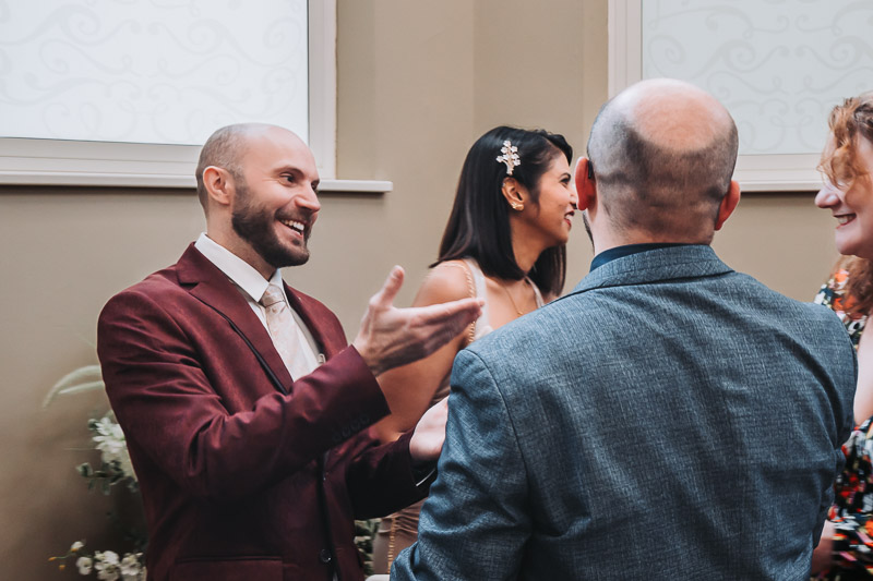Bride and groom sharing a candid moment during ceremony in Reading Berkshire